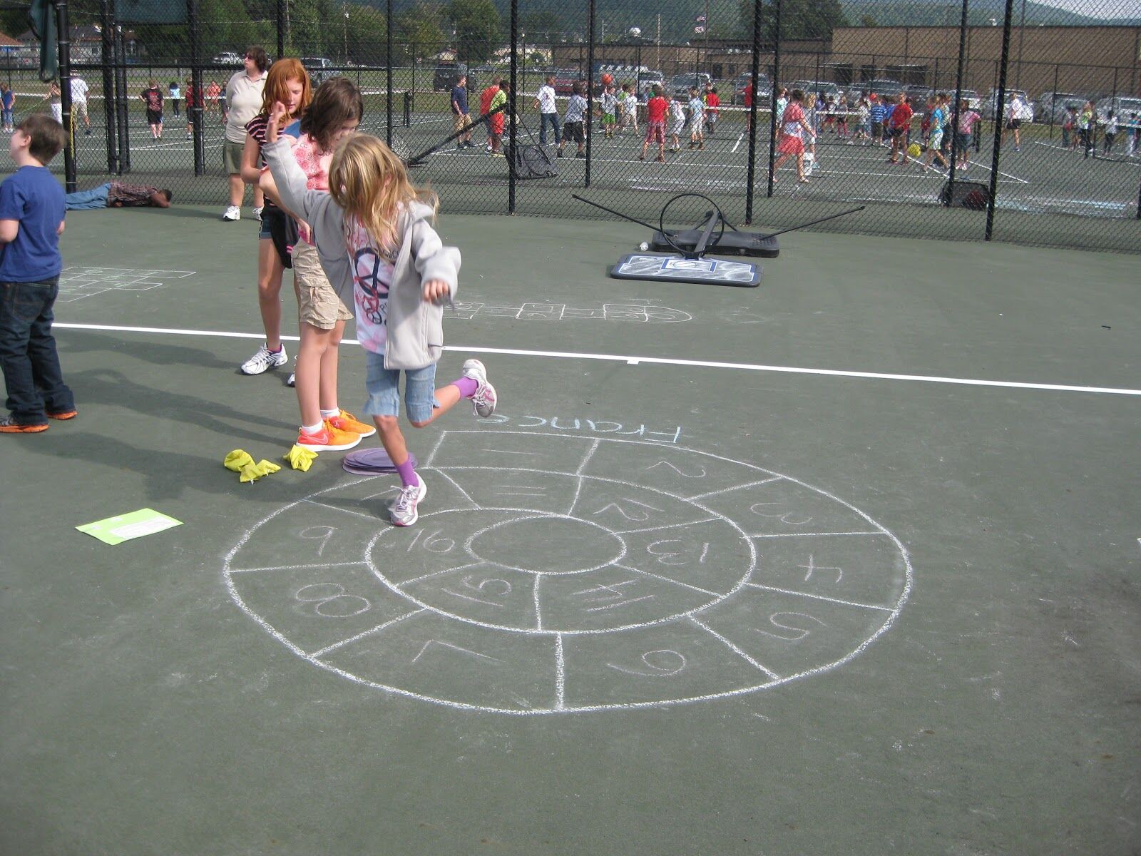 girl jumping around snail hopscotch board